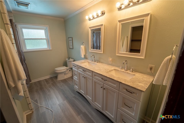 bathroom featuring hardwood / wood-style flooring, vanity, toilet, and crown molding