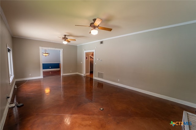 empty room with dark tile patterned flooring, ceiling fan, and crown molding