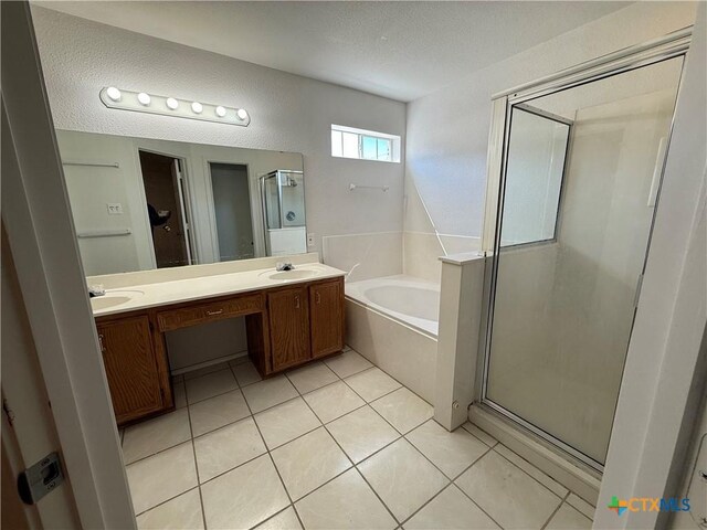 3054 Colorado Dr, Copperas Cove, TX 76522 - bathroom with a garden tub, a shower stall, double vanity, a textured ceiling, and tile patterned floors
