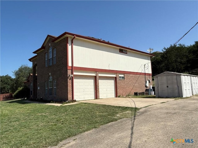 3054 Colorado Dr, Copperas Cove, TX 76522 - view of side of home with concrete driveway, brick siding, a storage shed, and a lawn