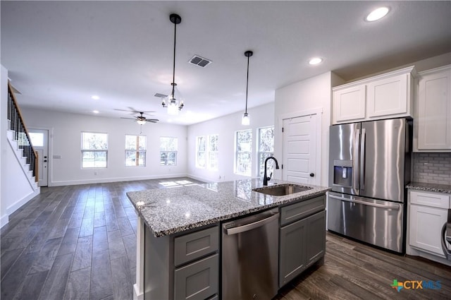 kitchen with ceiling fan, sink, dark hardwood / wood-style floors, decorative light fixtures, and appliances with stainless steel finishes