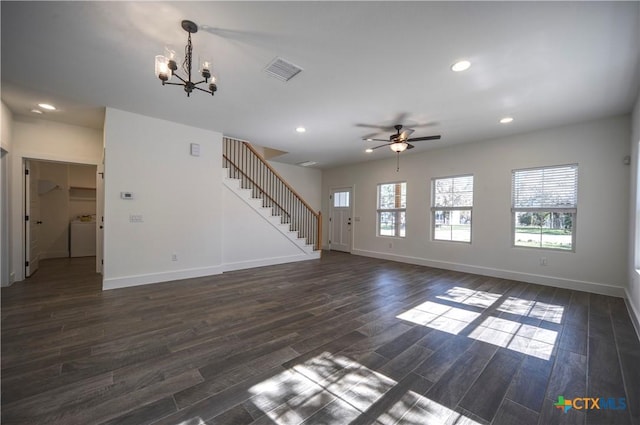 unfurnished living room with ceiling fan with notable chandelier, dark hardwood / wood-style flooring, and washer / dryer