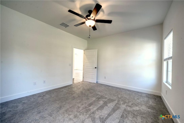 spare room featuring carpet flooring and ceiling fan