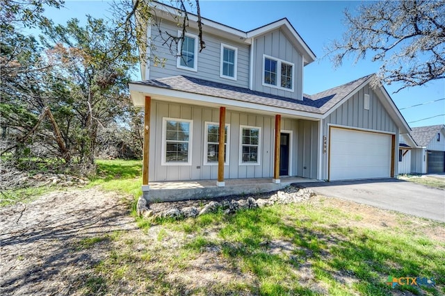 view of front of property with a porch and a garage