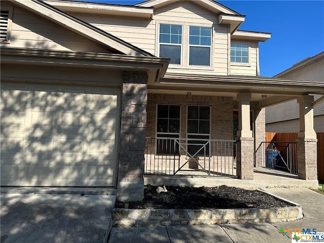 view of front of house with a porch and brick siding