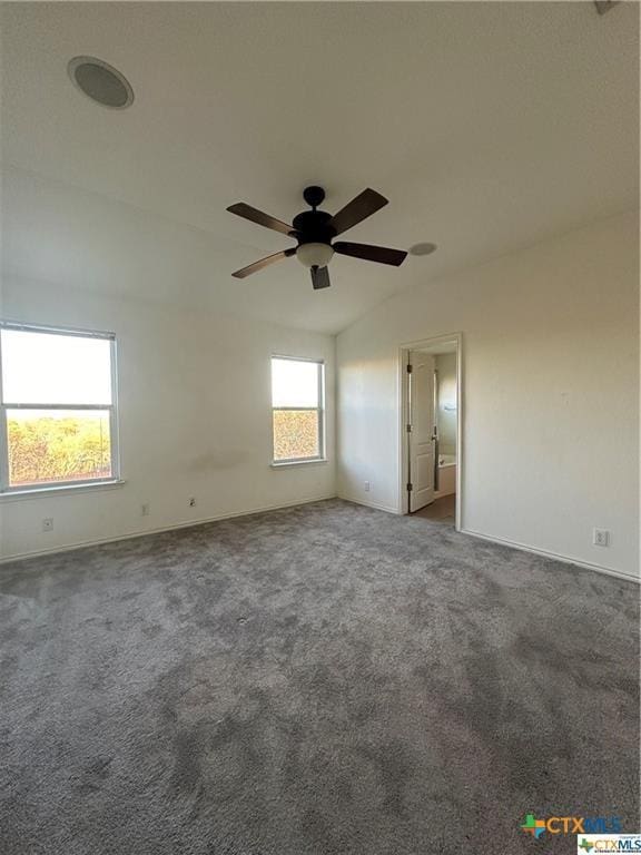 carpeted empty room featuring ceiling fan and baseboards