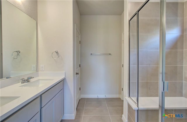 bathroom with tile patterned floors, vanity, and a shower with shower door