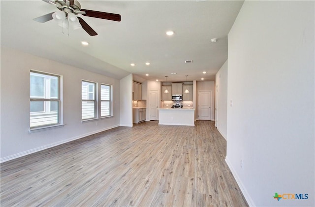 unfurnished living room featuring light hardwood / wood-style floors and ceiling fan