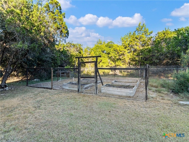 view of gate with a lawn