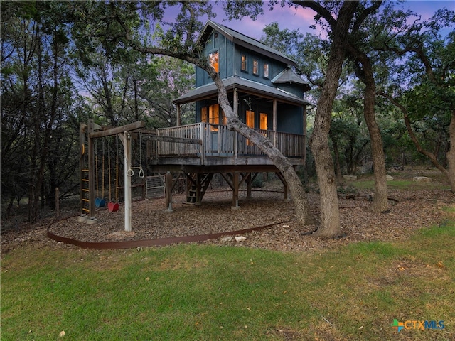 exterior space featuring a lawn and a deck