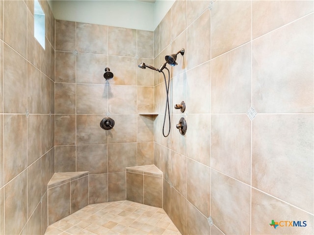 bathroom with a tile shower