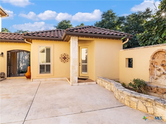 rear view of property featuring a patio area