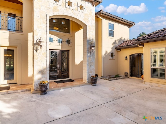 view of exterior entry featuring french doors