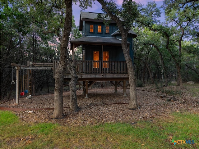 view of back house at dusk