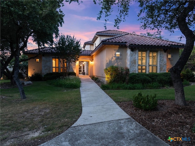 mediterranean / spanish-style home with a yard