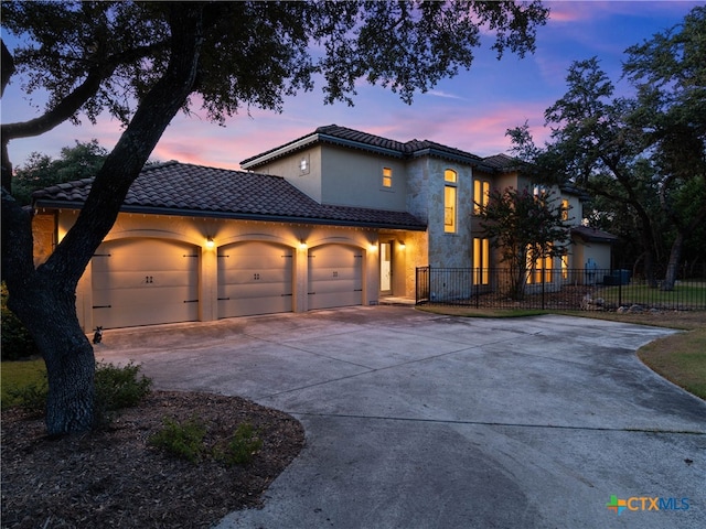 mediterranean / spanish-style house featuring a garage