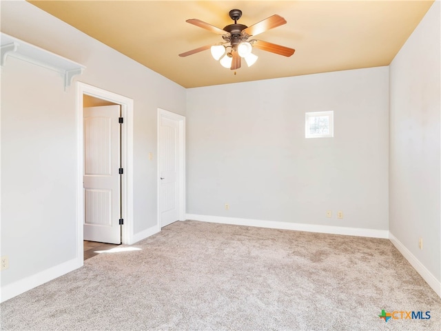 spare room with ceiling fan and carpet flooring