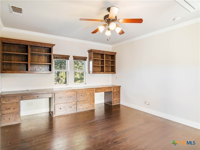 unfurnished office with ornamental molding, ceiling fan, built in desk, and dark hardwood / wood-style floors