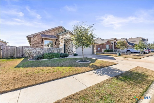 view of front of property with a front lawn and a garage