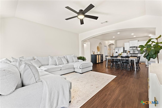 living room with lofted ceiling, dark wood-type flooring, and ceiling fan