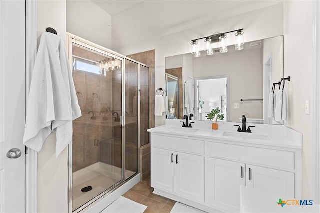 bathroom with vanity, tile patterned flooring, and a shower with shower door