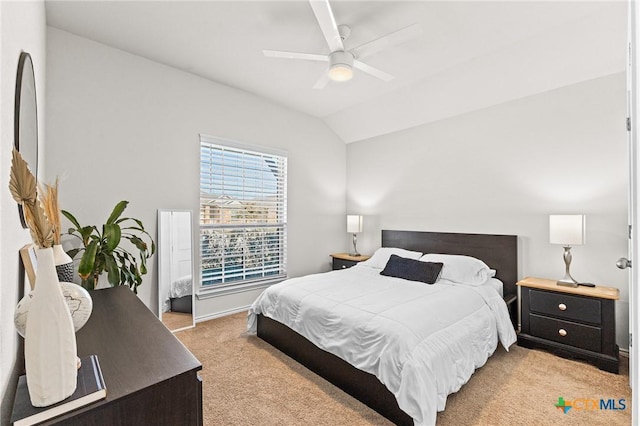 carpeted bedroom featuring vaulted ceiling and ceiling fan