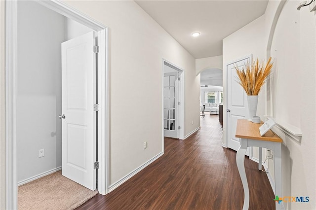 hallway with dark hardwood / wood-style flooring