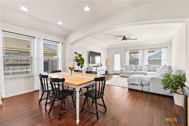 dining room featuring ceiling fan, dark hardwood / wood-style flooring, and vaulted ceiling