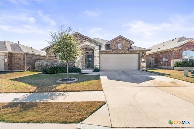 view of front of home with a front yard and a garage