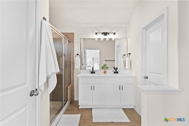 bathroom featuring vanity, tile patterned flooring, and a shower with shower door