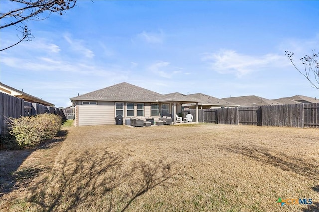 back of property featuring a yard and an outdoor hangout area