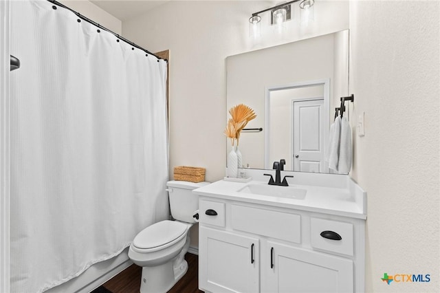 full bathroom with shower / tub combo, hardwood / wood-style floors, vanity, and toilet