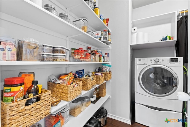 laundry area featuring dark hardwood / wood-style flooring and washer / dryer