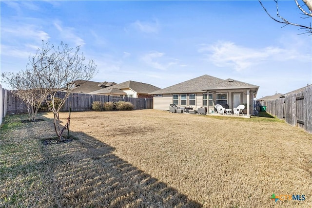 rear view of property with a patio, a yard, and outdoor lounge area