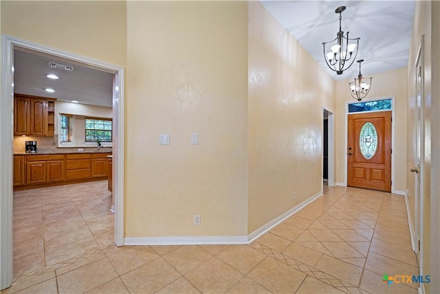 103 River Mdw, Castroville, TX 78009 - entrance foyer with a chandelier, light tile patterned floors, baseboards, and a high ceiling