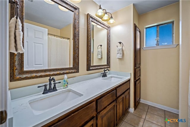 103 River Mdw, Castroville, TX 78009 - bathroom with tile patterned floors, double vanity, and baseboards