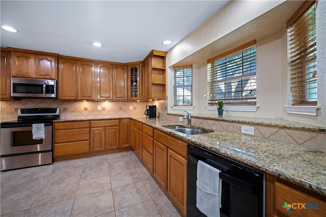 103 River Mdw, Castroville, TX 78009 - kitchen featuring stainless steel appliances, a sink, light stone counters, tasteful backsplash, and recessed lighting