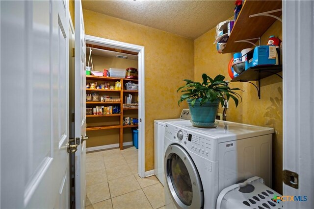 103 River Mdw, Castroville, TX 78009 - washroom featuring independent washer and dryer, a textured ceiling, and light tile patterned floors