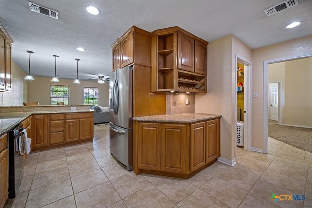 103 River Mdw, Castroville, TX 78009 - kitchen featuring stainless steel fridge, brown cabinetry, ceiling fan, recessed lighting, and light stone counters