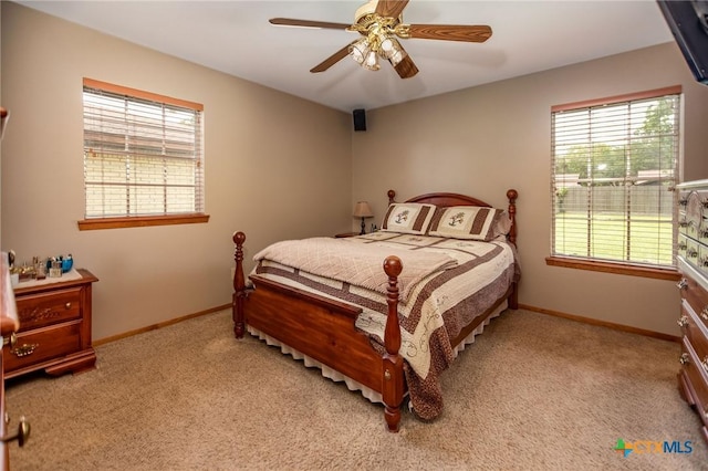 1617 Avalon St, Port Lavaca, TX 77979 - bedroom with multiple windows, light carpet, and a ceiling fan