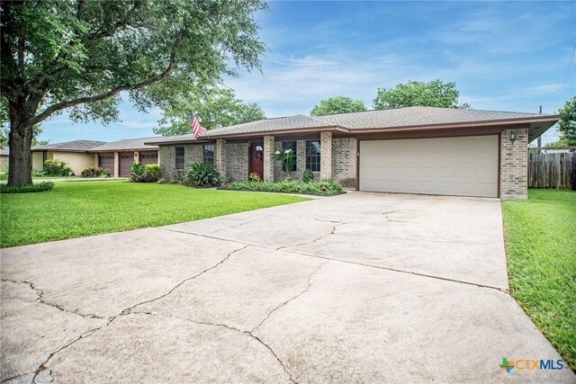 1617 Avalon St, Port Lavaca, TX 77979 - ranch-style house featuring an attached garage, driveway, and brick siding