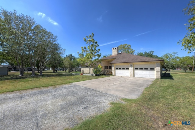 view of front of house with a front yard and a garage