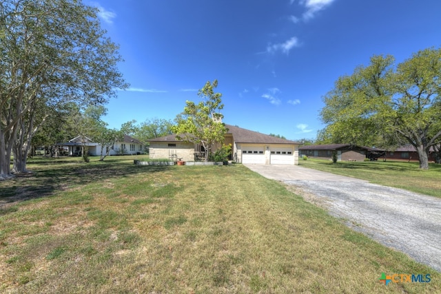 ranch-style home with a garage and a front yard