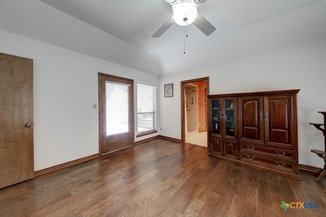 empty room featuring hardwood / wood-style floors, a textured ceiling, and ceiling fan