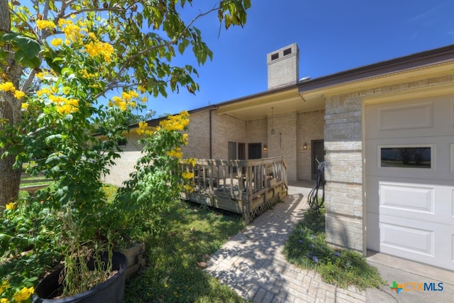 view of exterior entry featuring a deck