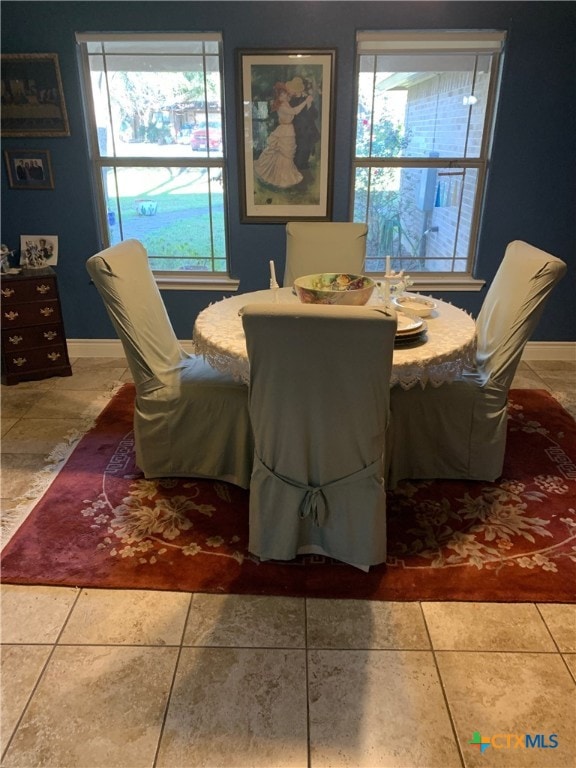 dining room with baseboards and tile patterned floors