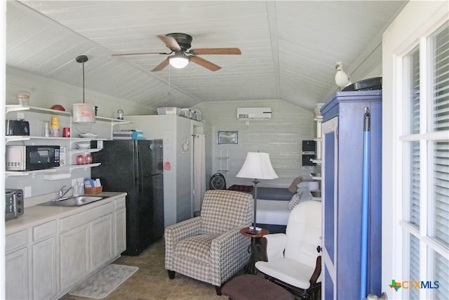 interior space with lofted ceiling, black appliances, sink, an AC wall unit, and decorative light fixtures