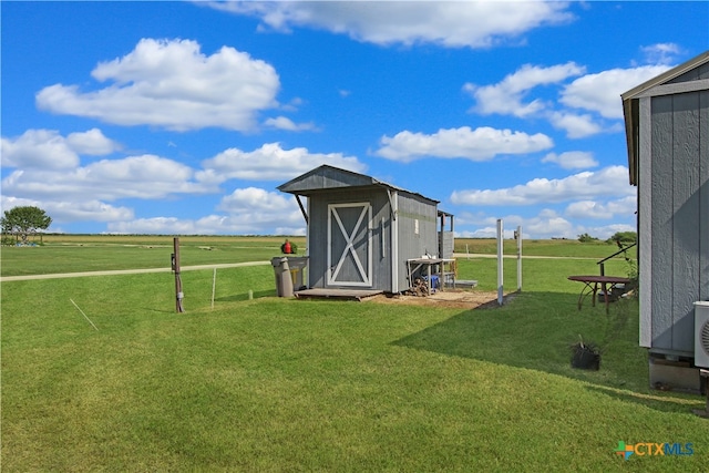 view of outbuilding with a yard and a rural view