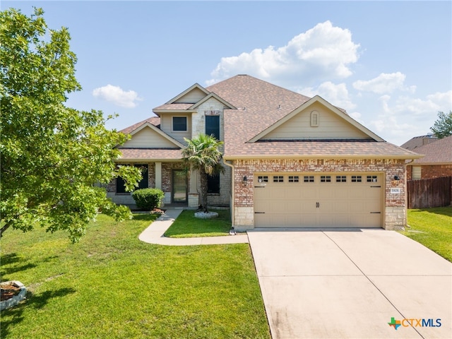 craftsman inspired home with a garage and a front lawn