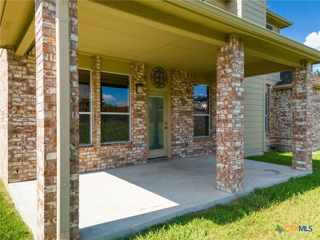 doorway to property with a patio area